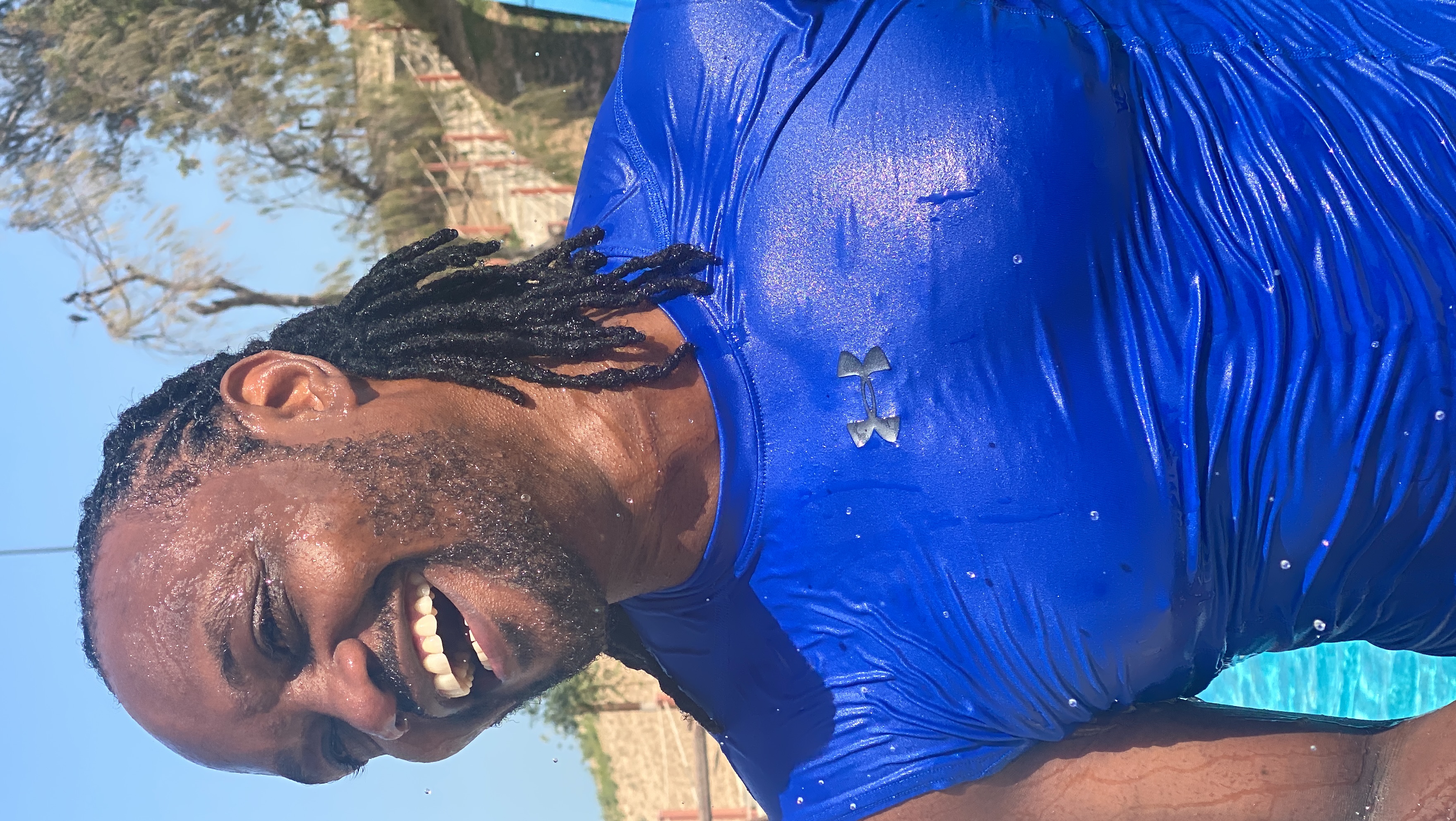 Peter Maina, founder and coach at Fitness Express, smiling after outdoor training
